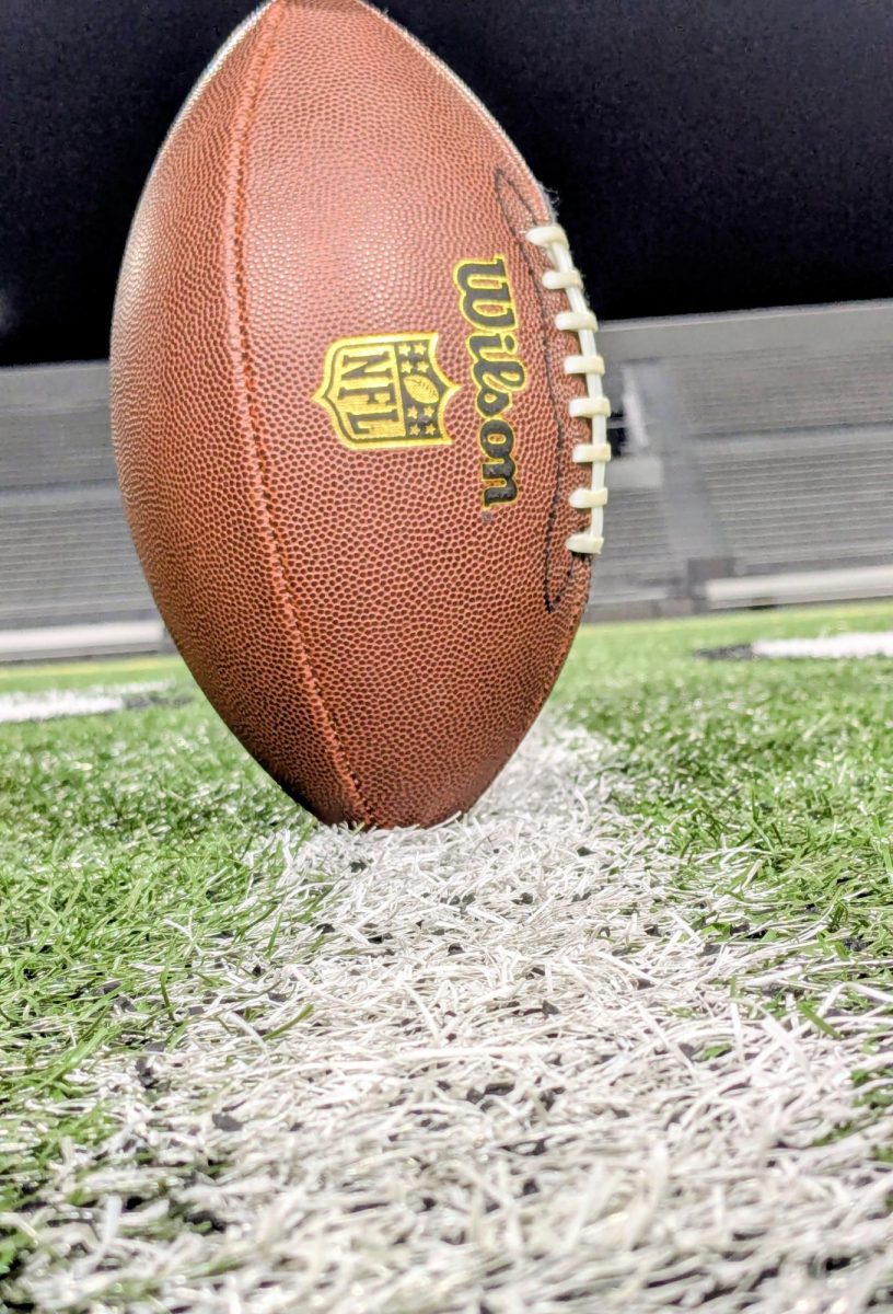 A football posed at Kingston Stadium, where the Cedar Rapids Washington Warriors play.